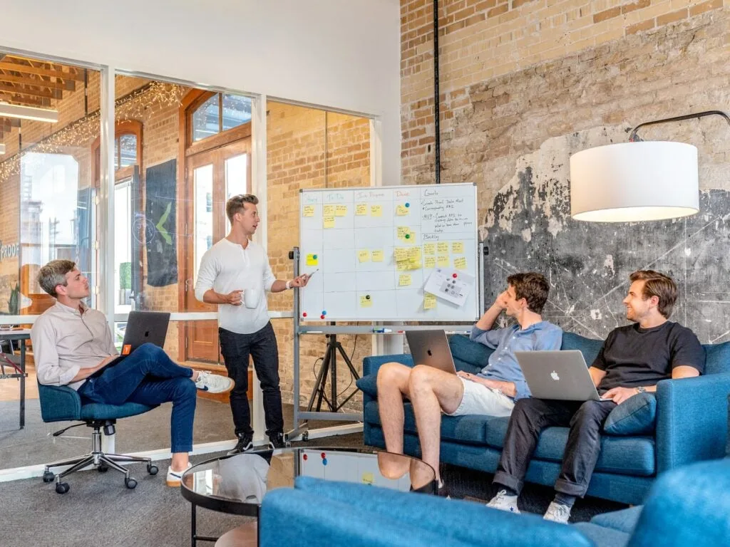 A group of team members discusses the most effective sales operations tactics without considering real-time analytical data.