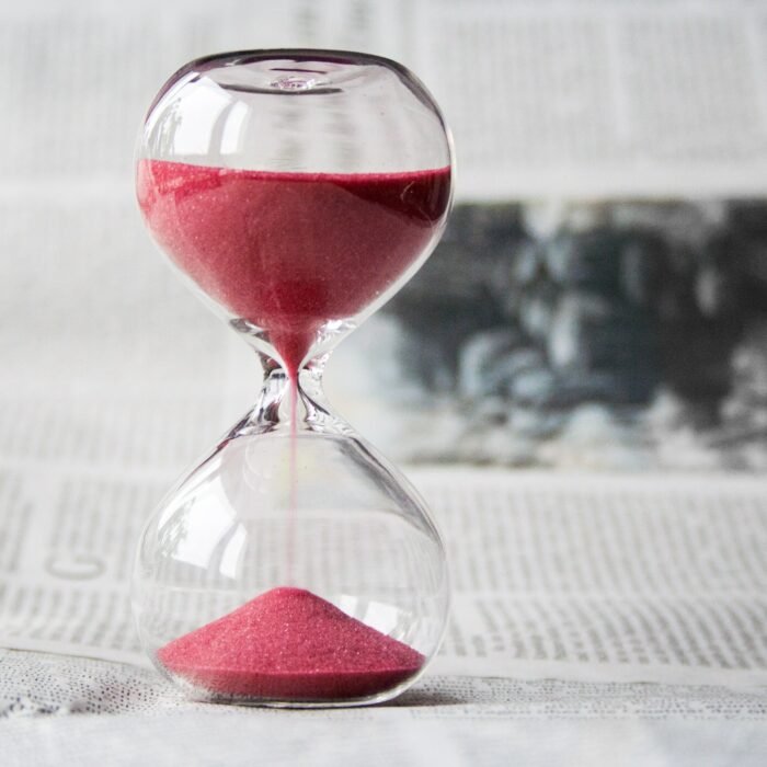 Glass timer filled with sand representing trying to figure out the right time what to sell and when to sell it.